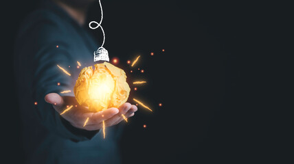 Poster - businessman holding yellow scrap paper ball with illustration painting for virtual lightbulb. it is 