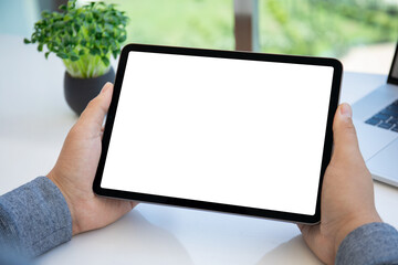 male hands holding computer tablet with isolated screen in office