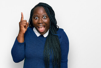 Poster - Young black woman with braids wearing casual clothes pointing finger up with successful idea. exited and happy. number one.