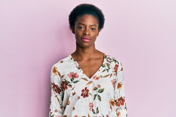 Wall Mural - Young african american girl wearing casual clothes relaxed with serious expression on face. simple and natural looking at the camera.