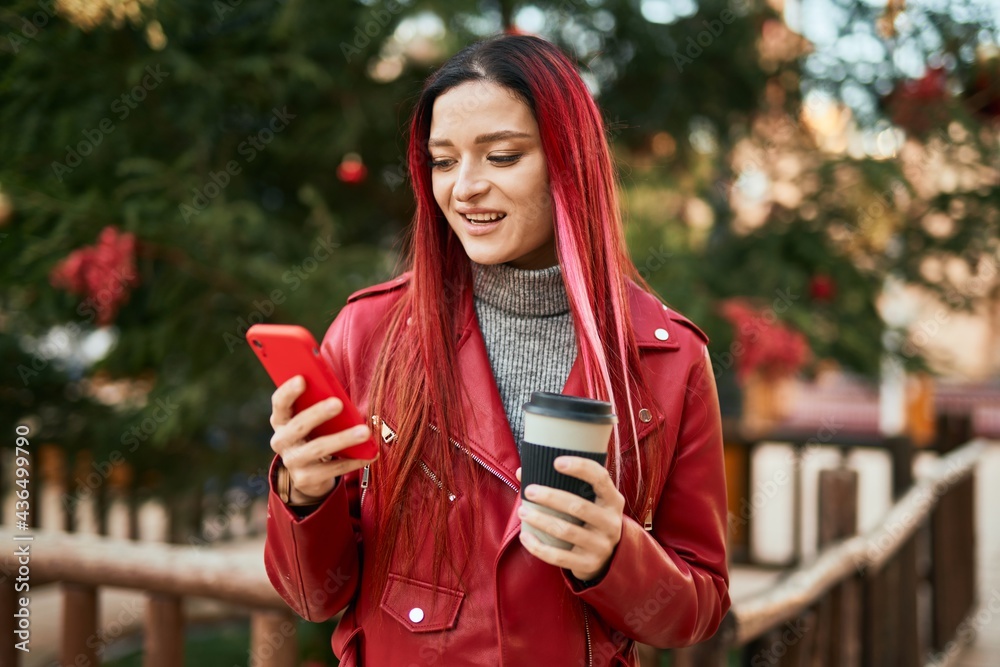 Young caucasian girl smiling happy using smartphone and drinking coffee at the city.