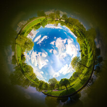 Panoramic View From Drone, Green Little Planet And Blue Sky Around The Globe