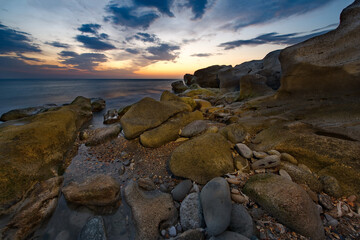 Wall Mural - Russia. Dagestan. Dawn on the rocky shore of the Caspian Sea near the city embankment of Makhachkala.