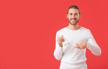 Poster - Handsome man with tooth brush and paste on color background