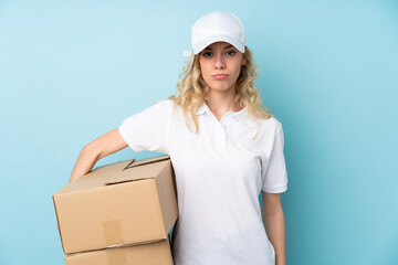 Poster - Young delivery woman isolated on blue background sad