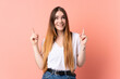 © luismolinero - Young caucasian woman isolated on pink background pointing up a great idea