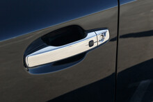 The chrome-plated door handle of a modern black car. Close-up car detail. Car Keyless entry system. Modern security systems