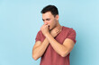 © luismolinero - Young caucasian handsome man isolated on blue background is suffering with cough and feeling bad