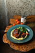 Beef ragout with brown spicy gravy and potato puree, hot comfort food on a wooden table, menu photo
