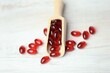 krill oil red gelatin capsules .omega fatty acids.Natural supplements and vitamins.Red capsules with krill oil in a wooden scoop 