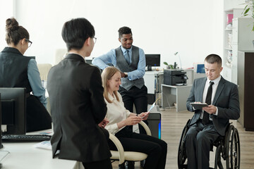 Aufkleber - Young intercultural subordinates interacting with boss in wheelchair
