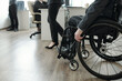 © pressmaster - Handicapped businessman in formalwear moving along open space office