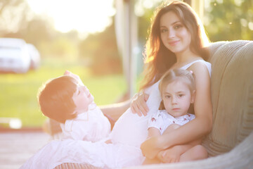 The family is resting in nature. Vacations in the fresh air. Weekend children play in the park.