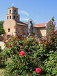 the exterior of the historic church of our lady of guadalupe and red roses  in santa fe, new mexico