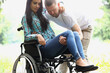 Man picks up disabled woman from wheelchair