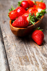 Wall Mural - Ripe strawberries in a wooden bowl