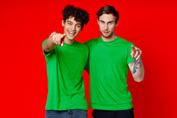 Two cheerful friends hug green t-shirts emotions 