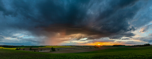 Wall Mural - evening storm at sunset over the beautiful rural areas