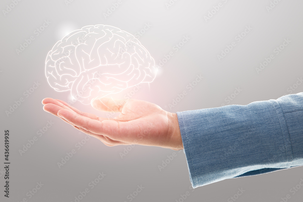 Female doctor holding brain illustration against the gray background. Mental health protection and care - obrazy, fototapety, plakaty 