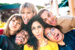 Multiethnic milenial people taking selfie sticking out tongue with happy faces - Funny life style and integration concept with interracial young friends having fun together