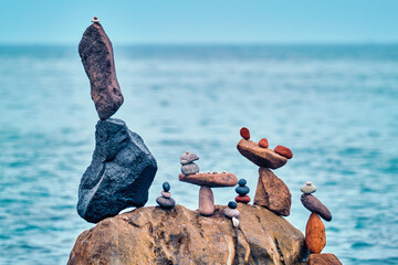 Wall Mural - Concept of balance and harmony - pebble stone stacks on the beach