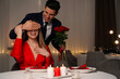 © New Africa - Man presenting roses to his beloved woman in restaurant at romantic dinner