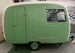 Side view of a green and white vintage caravan