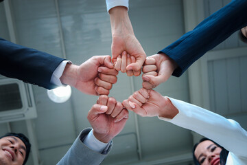 Businessman and woman putting hands fist join together, business partnership colleagues holding hands as commitment of strong team work, unity and teamwork Join hands support concept