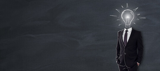 Poster - Business and creative idea concept with man in black suit with light bulb handwritten sketch instead of head on blank blackboard background. Mockup