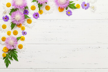 Wall Mural - Various garden flowers over wooden background