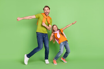 Poster - Full length body size view of attractive cheerful people dancing fooling having fun isolated over green color background