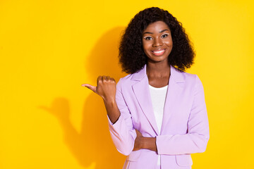 Sticker - Photo of young happy cheerful smiling afro woman point finger copyspace advertisement isolated on yellow color background