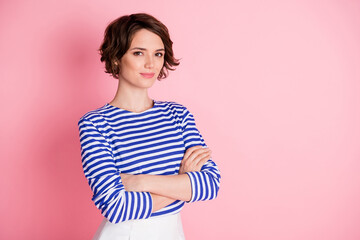 Wall Mural - Photo of charming lady crossed arms self-assured look camera smile wear striped shirt isolated pastel pink color background