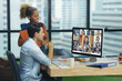 © sutlafk - Business team using computer for a online meeting in video call. Side view of business people talking to colleagues about plan in video conference. Group of person smart working from home office.