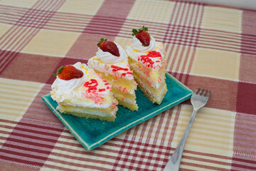 Canvas Print - Closeup of white vanilla sponge cake slices on a blue plate