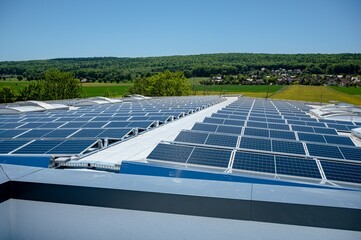 Large solar plant on an industrial hall generates renewable energy