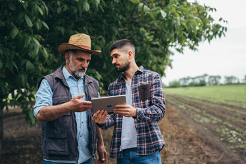 agricultural subsidies. workers talking in orchard