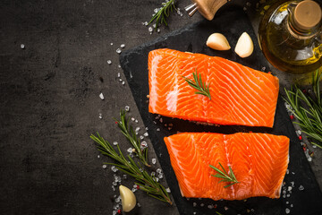 Poster - Fresh fish. Raw salmon fillet at cutting board with ingredients for cooking. Top view with copy space.