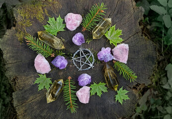 Wall Mural - mineral gemstones, pentagram and forest leaves on natural background. healing quartz stones for crys