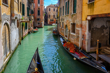 Wall Mural - Narrow canal with gondola in Venice, Italy. Architecture and landmark of Venice. Cozy cityscape of Venice.