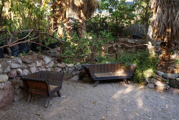 Quiet corner of a green garden with cozy bench