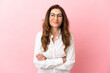 © luismolinero - Middle aged caucasian woman isolated on pink background keeping the arms crossed in frontal position
