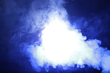 Poster - Artificial smoke in blue light on black background