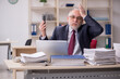 © Elnur - Aged male employee and too much work at workplace