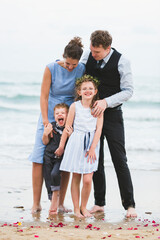 Wall Mural - Cheerful family at beach wedding ceremony