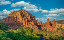 Aerial View Of Famous Sedona Red Rock Formations: Cathedral Rock, Bell Rock, Courthouse Butte In Arizona With Blue Cloudy Sky