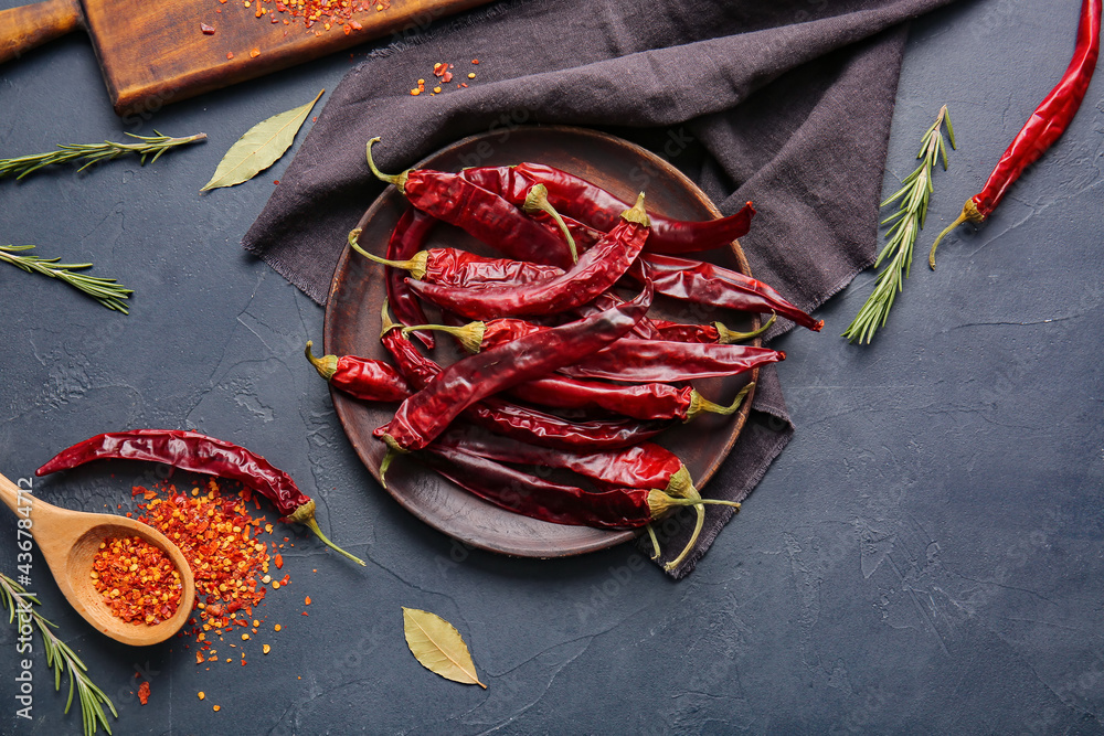 Composition with hot chili pepper on dark background