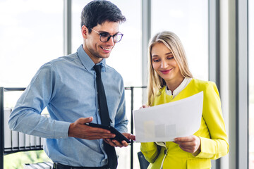 Two professional business man and woman meeting and discussing strategy with new startup project.Creative business people planning and brainstorm in modern office.Teamwork