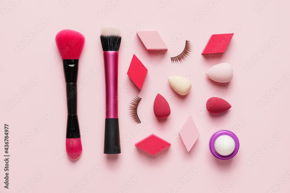 Set of makeup items on color background