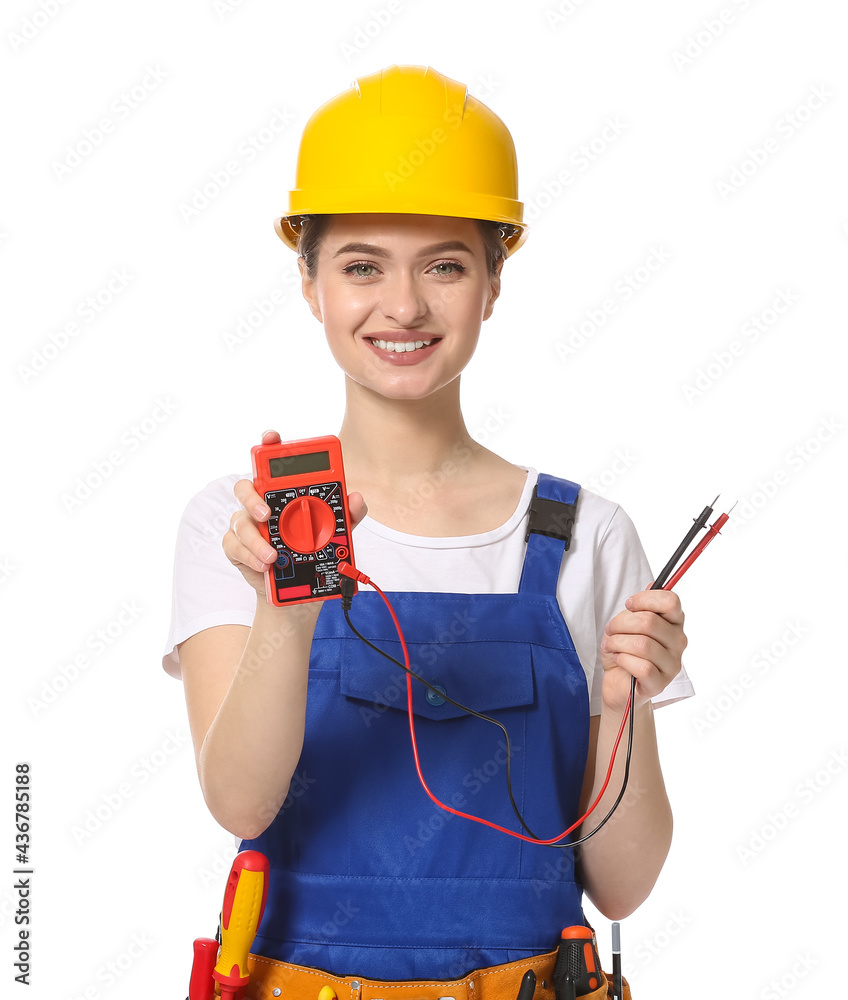 Beautiful female electrician with multimeter on white background